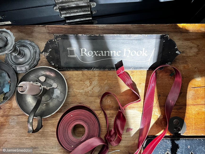 Peter Pans Neverland Nightmare: Roxy Hook&#39;s sewing desk. With the name-tag prop i made on-set on the day of the shoot from scavenged materials and a rogue printer..